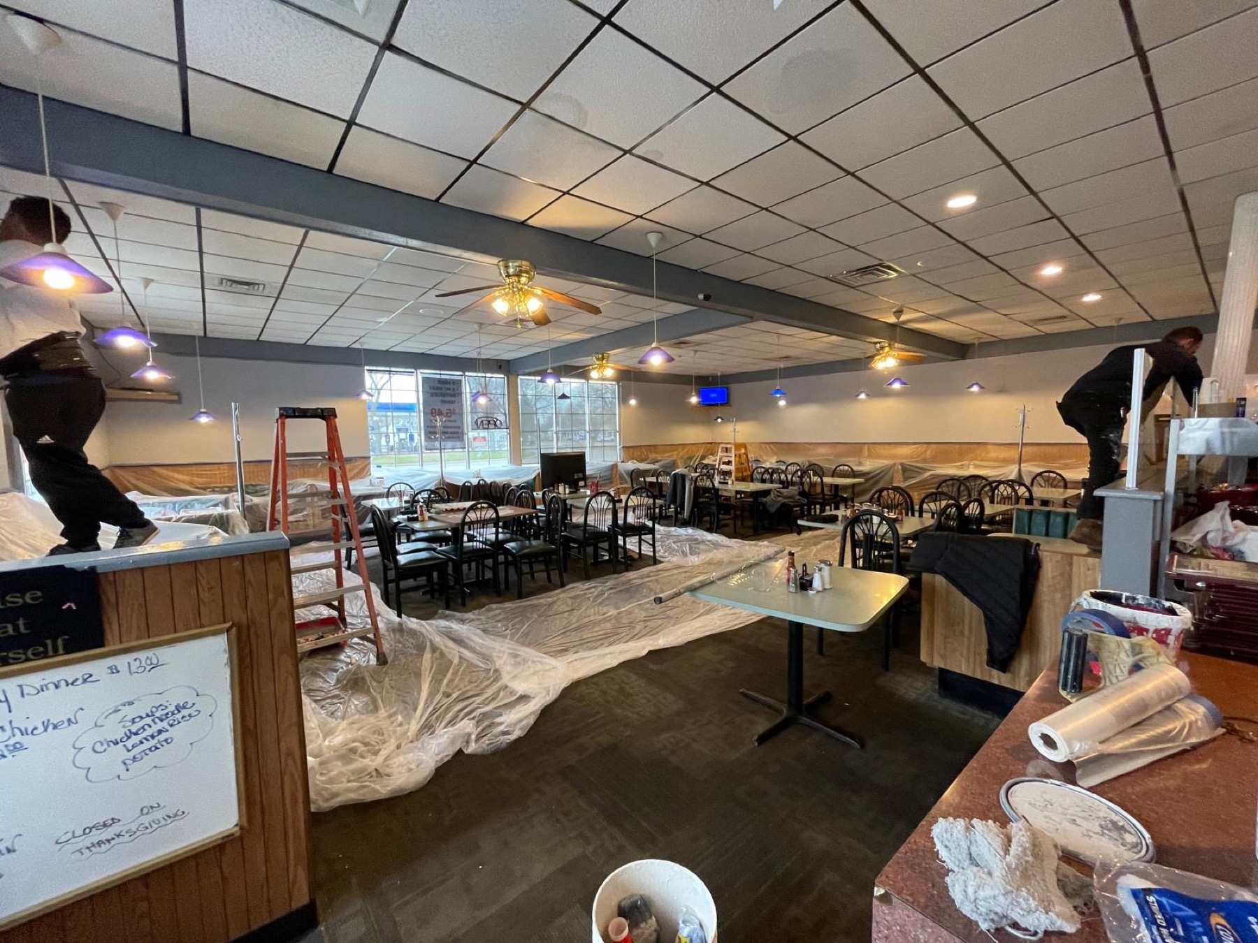 Restaurant dining room protected and prepared for painting